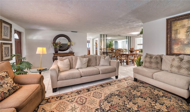 tiled living room featuring a textured ceiling