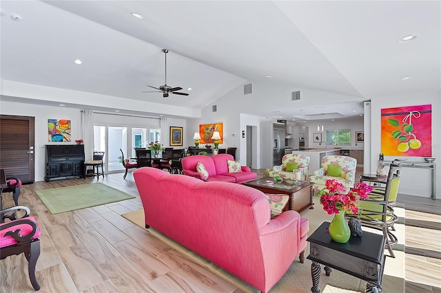 living room featuring light wood-type flooring, high vaulted ceiling, and ceiling fan