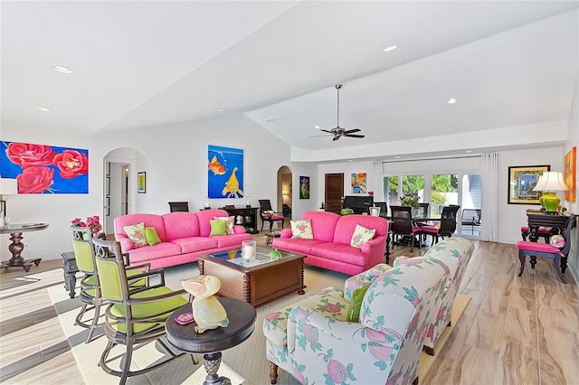 living room with light hardwood / wood-style floors, vaulted ceiling, and ceiling fan