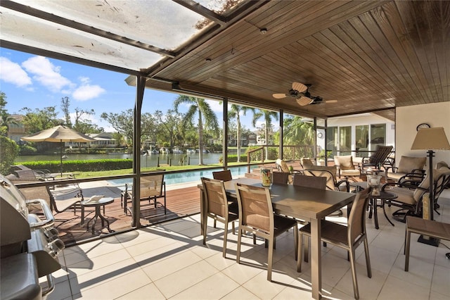 sunroom / solarium with a water view and a healthy amount of sunlight