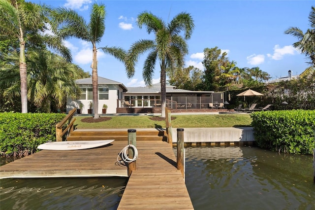 dock area with a water view and a yard