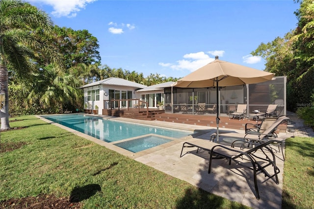 view of pool with a sunroom, a yard, a wooden deck, an in ground hot tub, and a patio