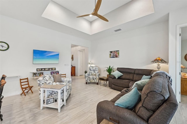 living room featuring ceiling fan and light hardwood / wood-style floors