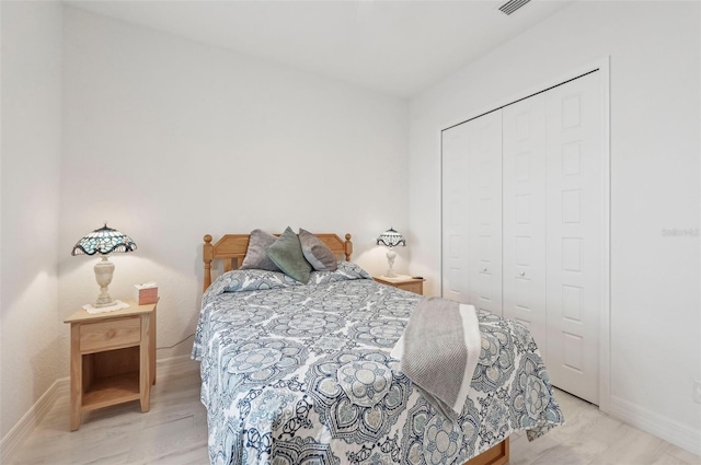 bedroom featuring light wood-type flooring and a closet