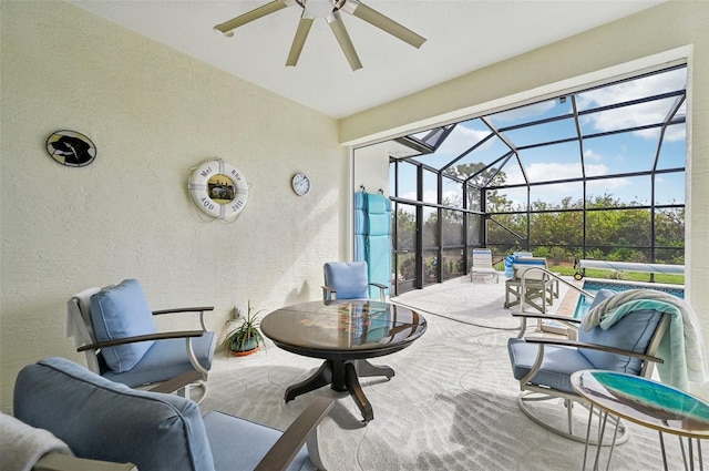 view of patio with glass enclosure and ceiling fan