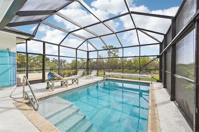 view of swimming pool with a patio and glass enclosure