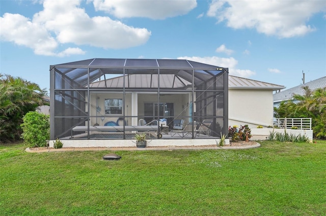 back of house featuring glass enclosure and a lawn