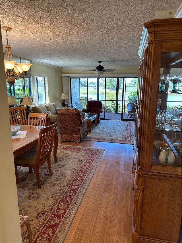 3500 El Conquistador Pkwy Unit 331, Bradenton, FL 34210 - dining space with a textured ceiling, ceiling fan, and light wood-style flooring