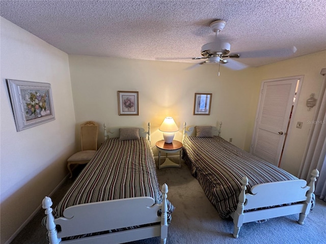 carpeted bedroom with ceiling fan and a textured ceiling