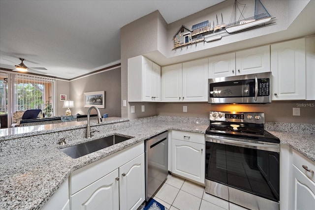 kitchen with white cabinets, stainless steel appliances, sink, and crown molding