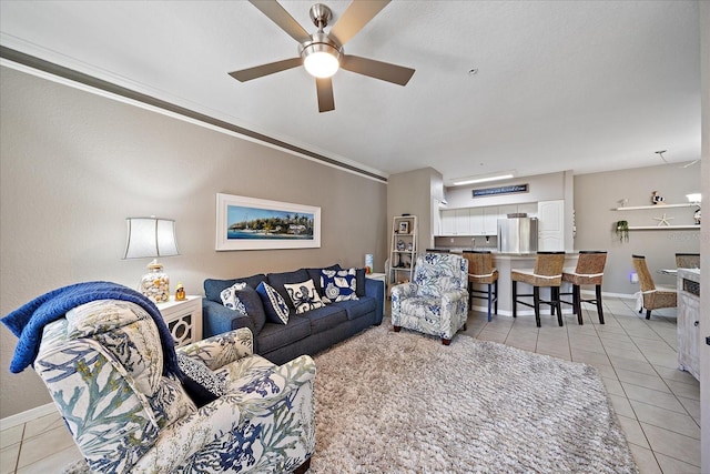 living room featuring light tile patterned flooring and ceiling fan