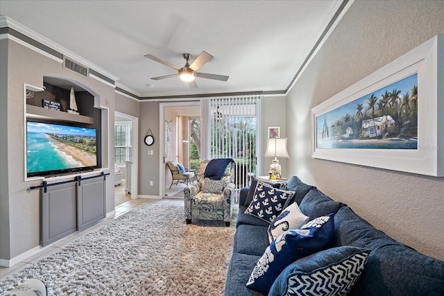 living room featuring ornamental molding, ceiling fan, and light tile patterned floors