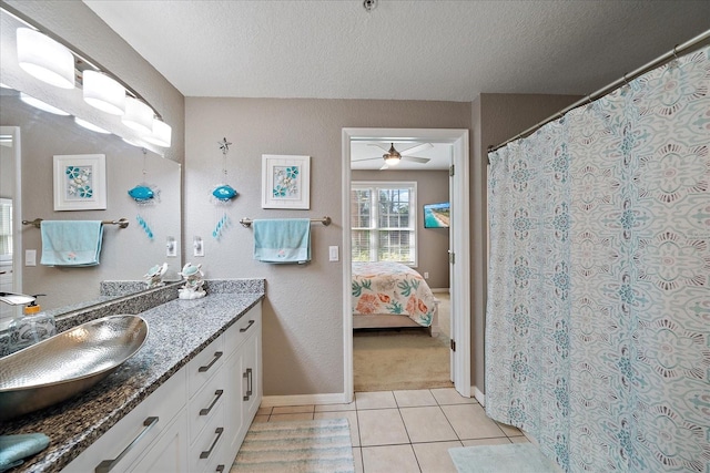 bathroom featuring vanity, a textured ceiling, tile patterned flooring, and ceiling fan