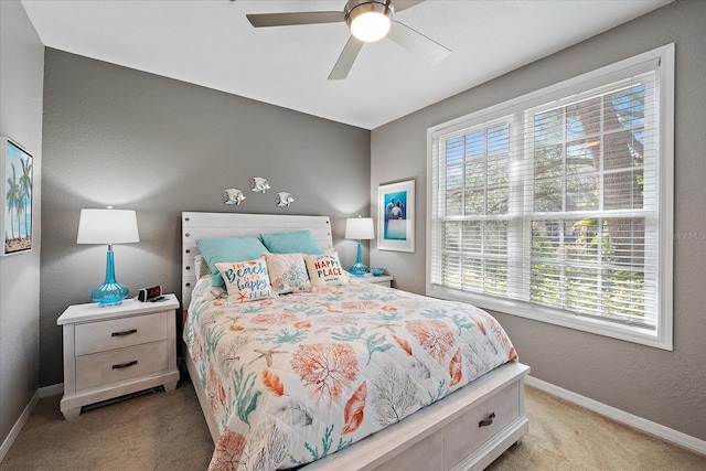 bedroom with light carpet and ceiling fan