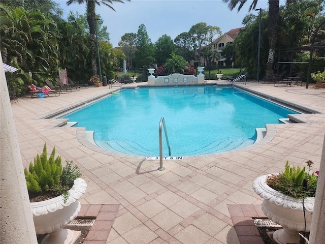 view of swimming pool featuring a patio area