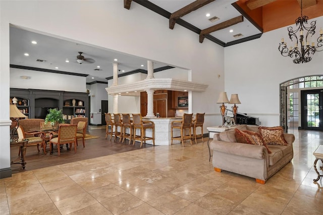 living room with ceiling fan, a high ceiling, beamed ceiling, and french doors