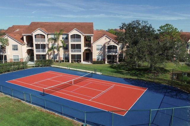 view of tennis court with basketball hoop