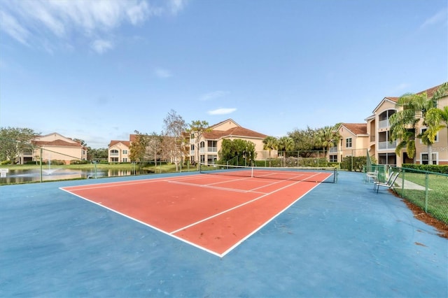 view of sport court featuring a water view and basketball court