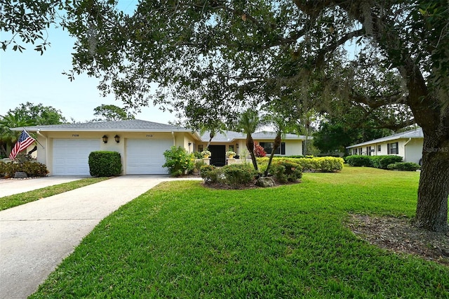 single story home featuring a garage and a front lawn