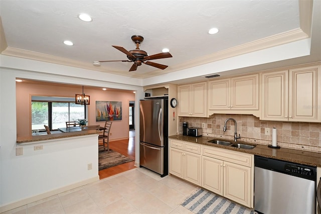 kitchen featuring sink, appliances with stainless steel finishes, cream cabinets, and crown molding