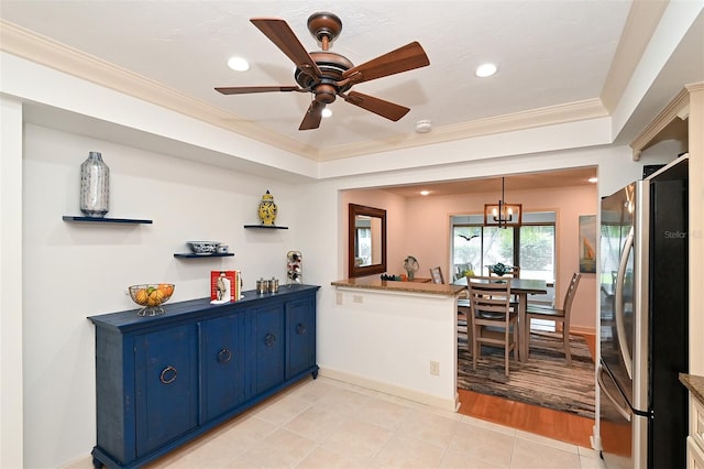 kitchen featuring blue cabinets, kitchen peninsula, crown molding, stainless steel refrigerator, and light wood-type flooring