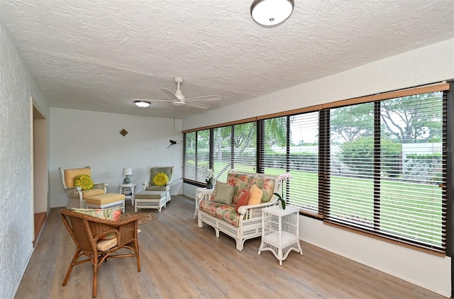 sunroom with a healthy amount of sunlight and ceiling fan