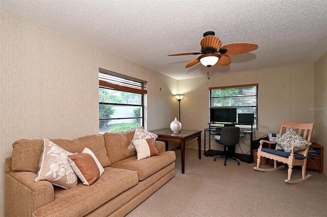 carpeted living room featuring a textured ceiling and ceiling fan