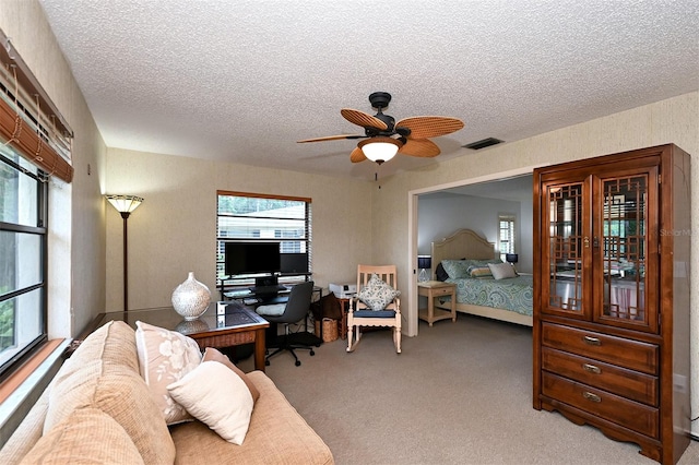 bedroom featuring carpet, a textured ceiling, and ceiling fan