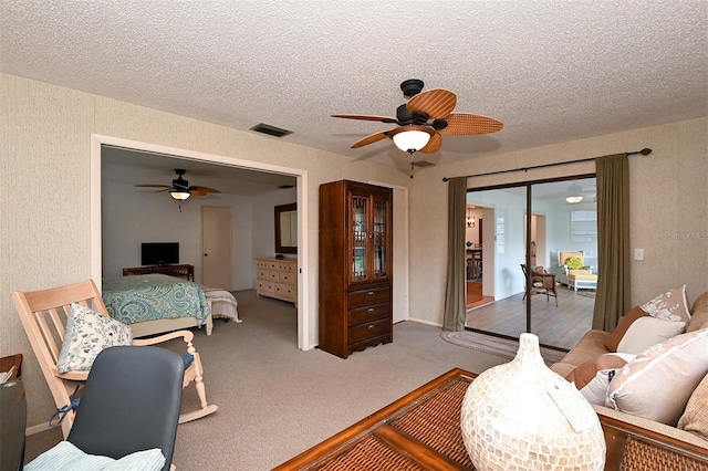 bedroom featuring ceiling fan, a textured ceiling, a closet, and carpet floors