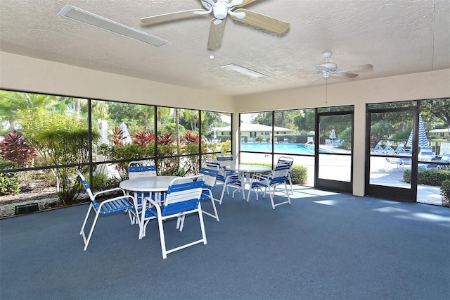 sunroom / solarium with ceiling fan