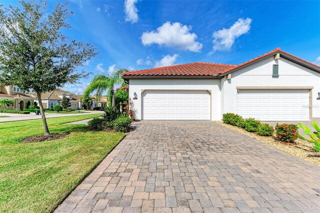 view of front of property with a garage and a front yard