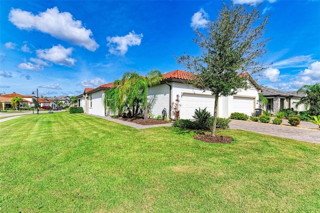 view of front of house with a garage and a front lawn