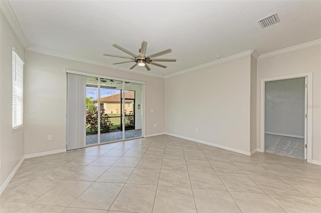 tiled spare room with ornamental molding and ceiling fan