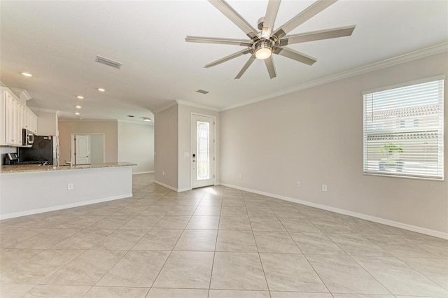 unfurnished living room with ceiling fan, light tile patterned floors, and ornamental molding