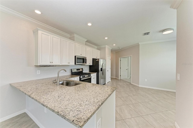 kitchen with light stone counters, crown molding, appliances with stainless steel finishes, sink, and white cabinets