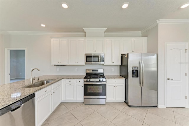 kitchen with white cabinetry, appliances with stainless steel finishes, sink, and crown molding