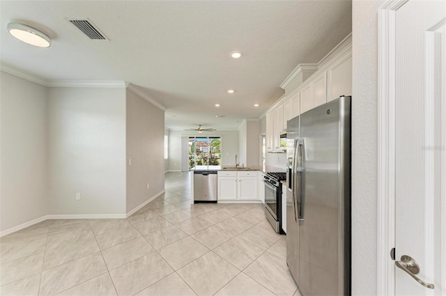 kitchen with crown molding, stainless steel appliances, white cabinetry, sink, and ceiling fan