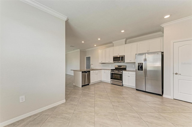 kitchen featuring ornamental molding, appliances with stainless steel finishes, sink, white cabinets, and kitchen peninsula