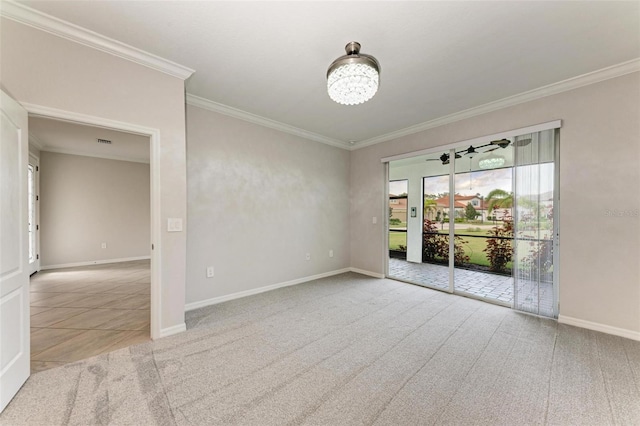 carpeted spare room with ornamental molding and an inviting chandelier