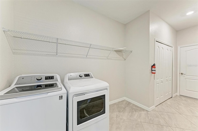 laundry room featuring independent washer and dryer and light tile patterned floors