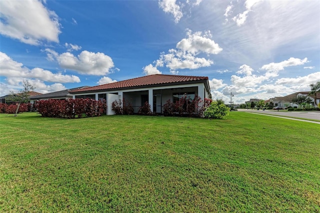 back of house featuring a lawn