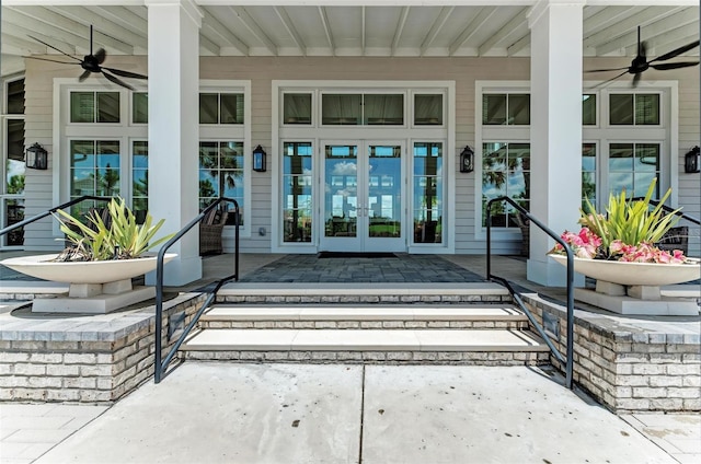 view of exterior entry featuring a porch, french doors, and ceiling fan