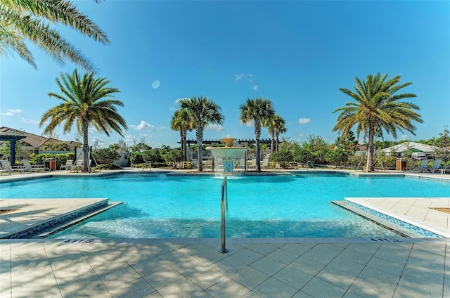 view of swimming pool with a patio and pool water feature