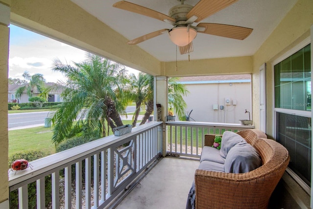 balcony featuring a porch and ceiling fan