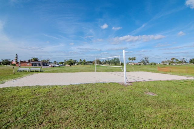 surrounding community with a lawn and volleyball court