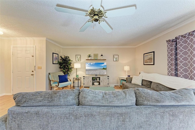 living room featuring wood-type flooring, a textured ceiling, ceiling fan, and ornamental molding