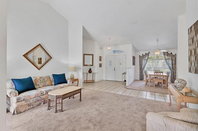 living room featuring light tile patterned floors and ceiling fan with notable chandelier