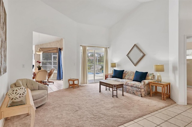 living room with light carpet and high vaulted ceiling