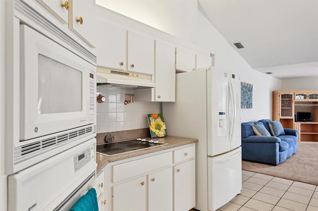 kitchen with light carpet, white appliances, tasteful backsplash, and white cabinetry