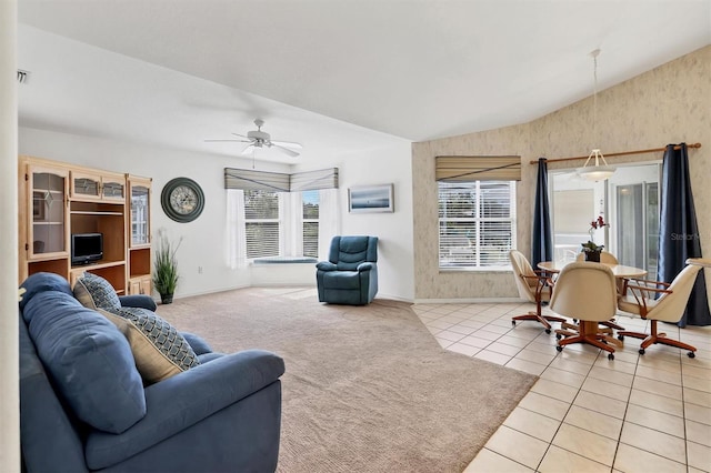 tiled living room featuring ceiling fan and vaulted ceiling